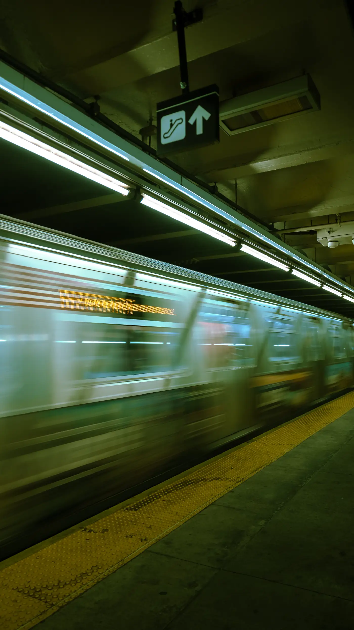 New York subway train moving through a station