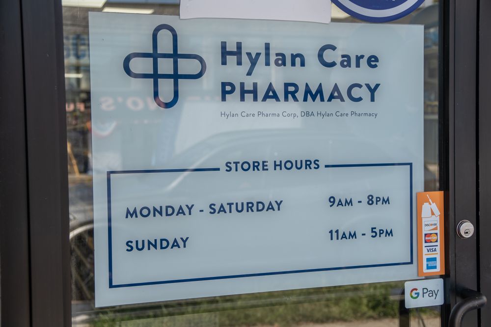 Hylan Care Pharmacy store-hours sign at the entrance
